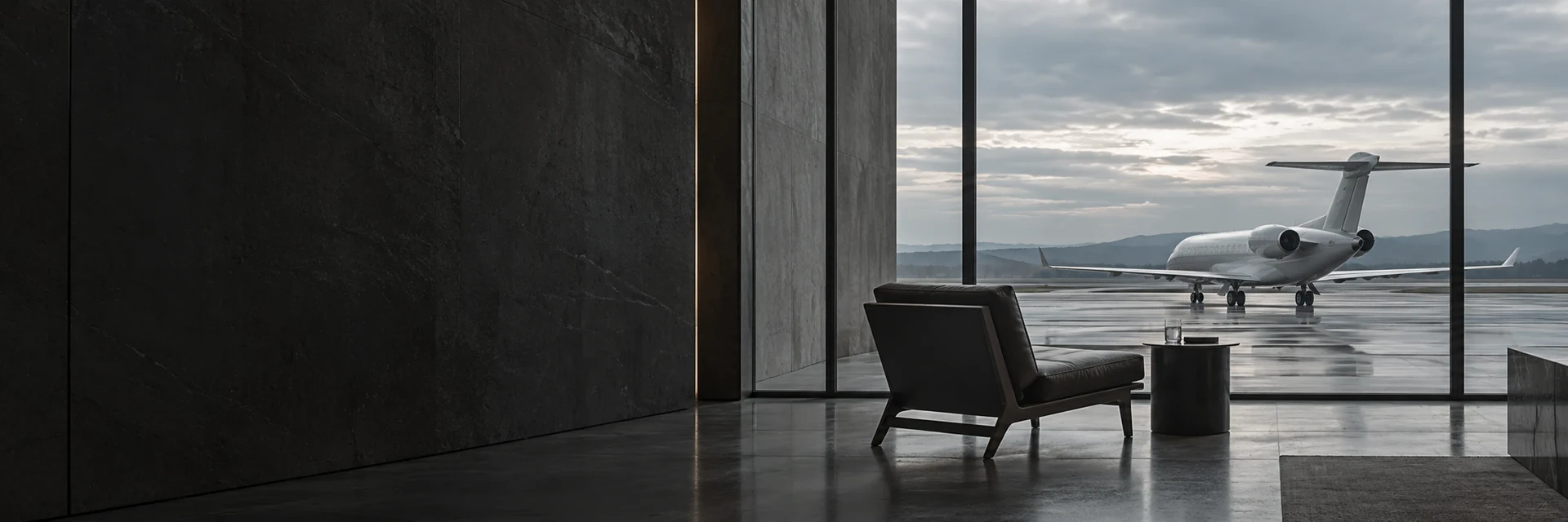 A stone lounge overlooking a private jet on a rain-wet apron.